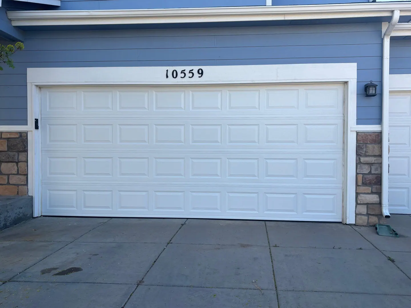 White garage door aligned and closed after repair