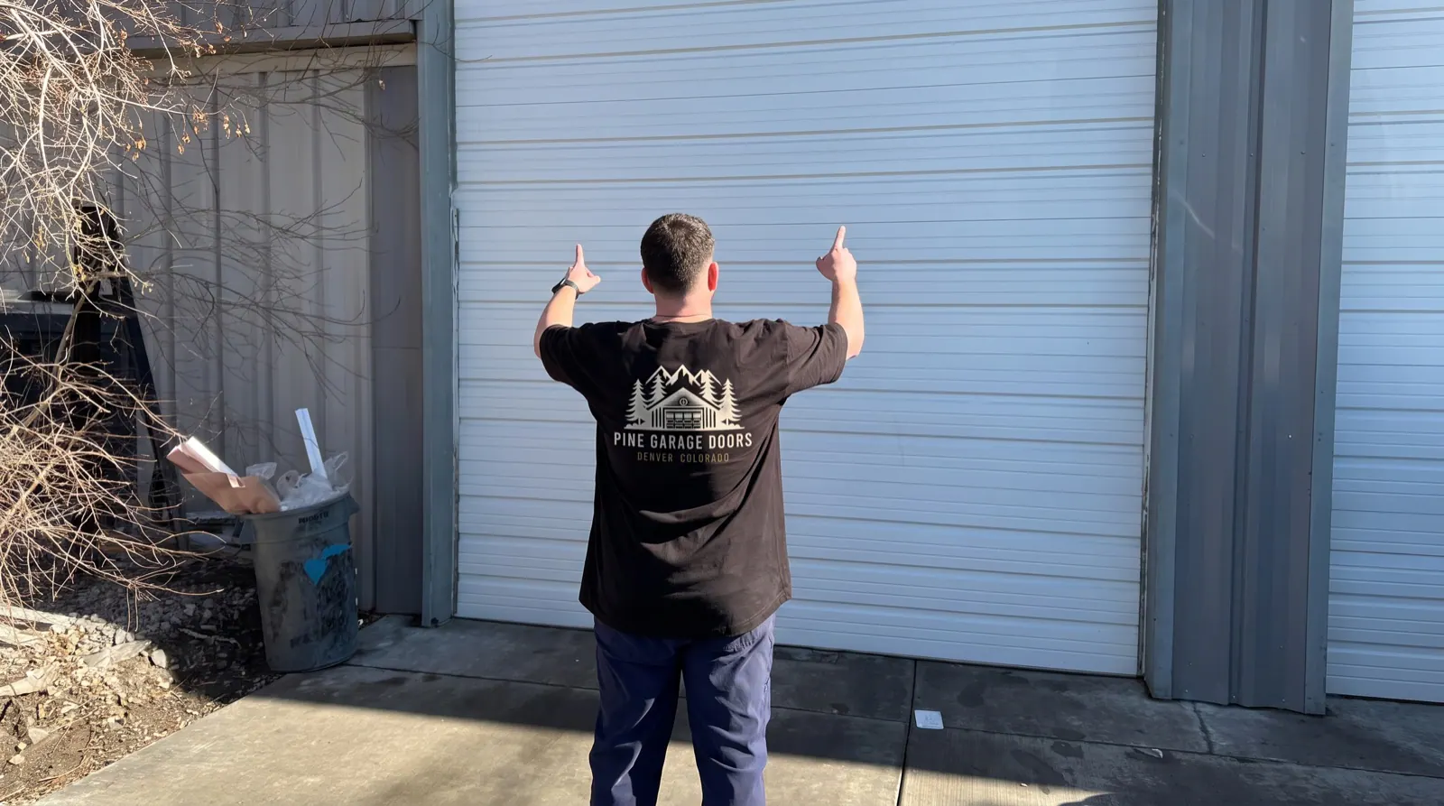 Pine technician inspecting a replacement garage door