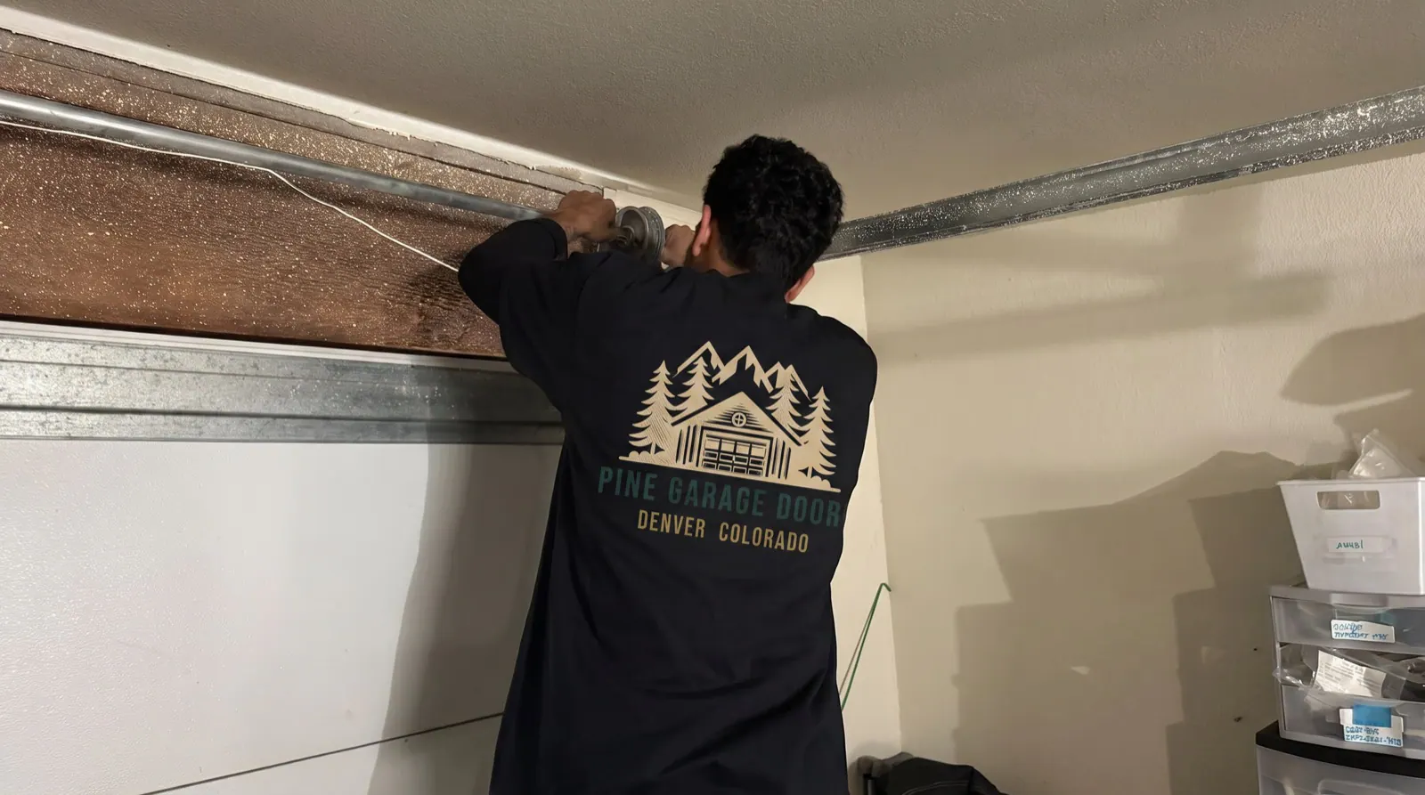 Pine technician repairing an off-track garage door