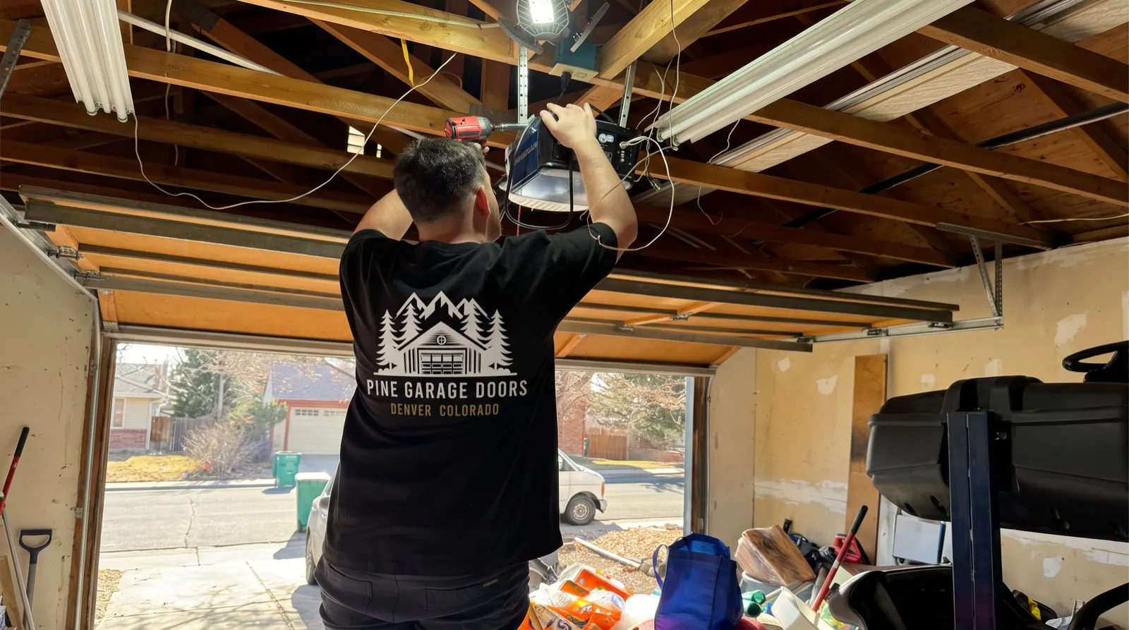 Pine technician repairing a garage door opener